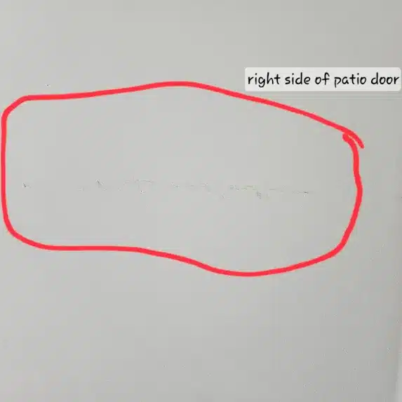 Scratched wall near patio door