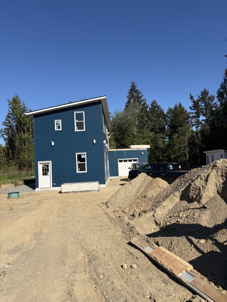 New house under construction with driveway Mill bay, BC