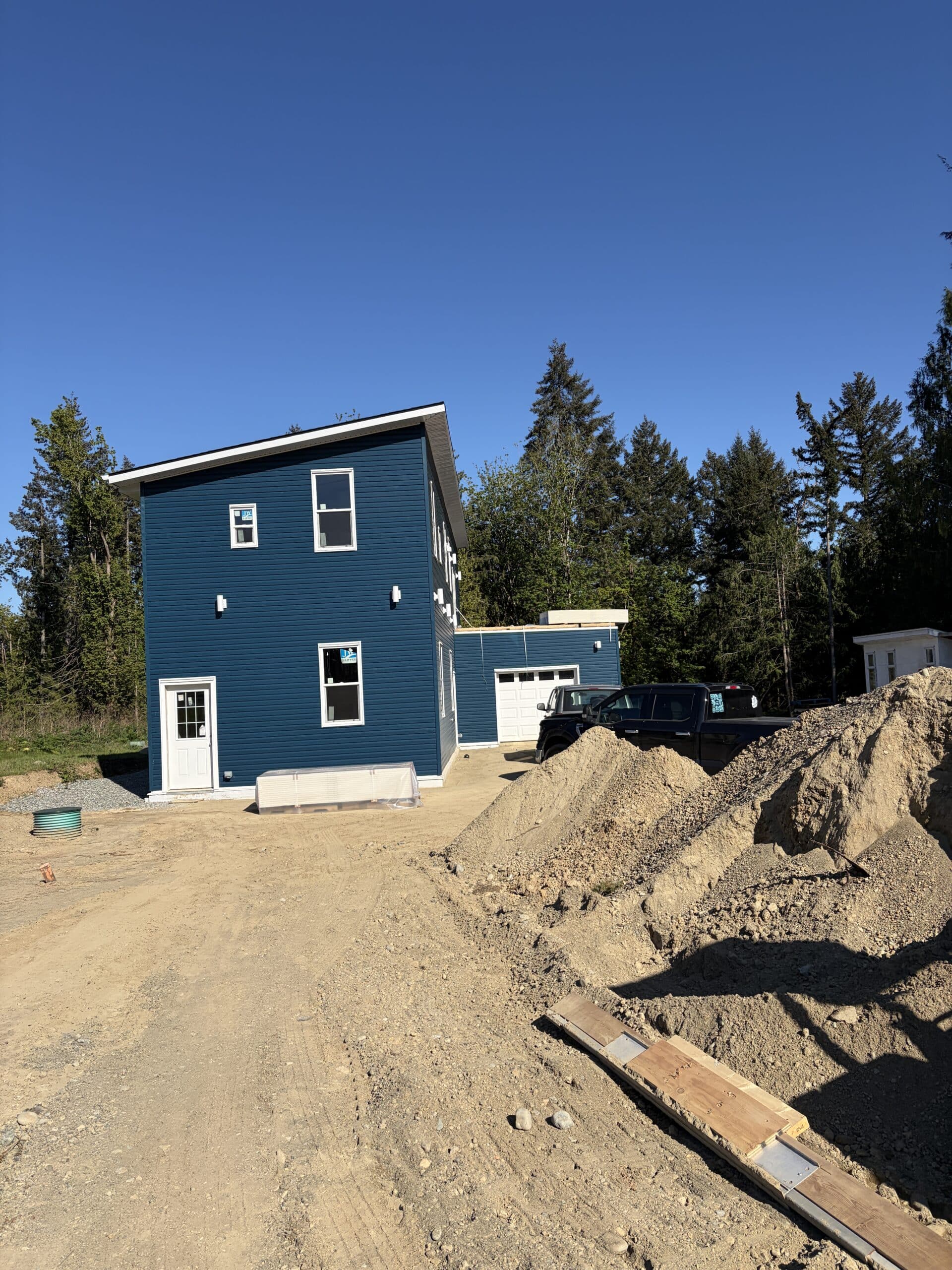 New house under construction with driveway Mill bay, BC